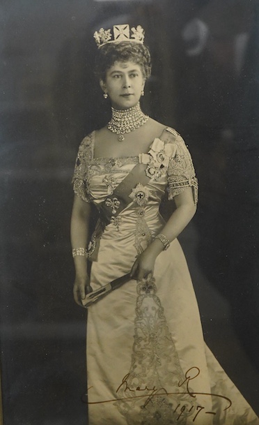 A framed photograph of Queen Mary, signed by the Queen across the bottom of the image and dated 1917, contained within a gilt padded mount and leather frame, overall dimensions 44 x 33cm